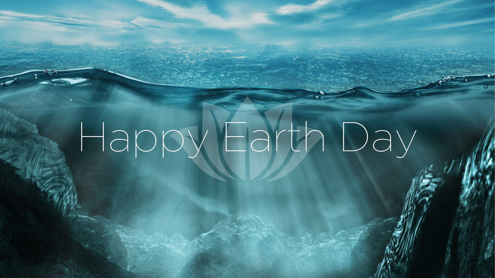 Ocean water. Happy Earth Day text with Lotus Logo faded in background.